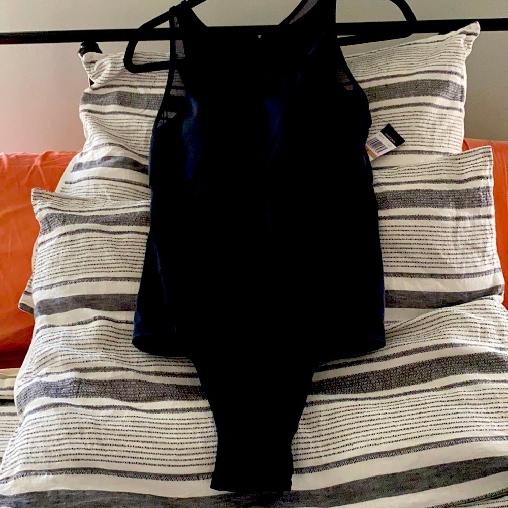 Black one-piece with mesh inset. High neck,hi-cut.